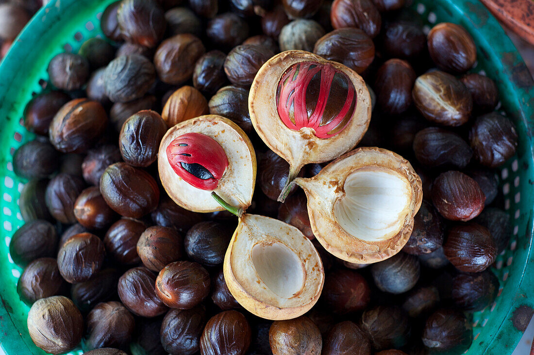 Male and female nutmegs, rind split open to reveal mace wrapped round nutmegs inside, Penang, Malaysia, Southeast Asia, Asia