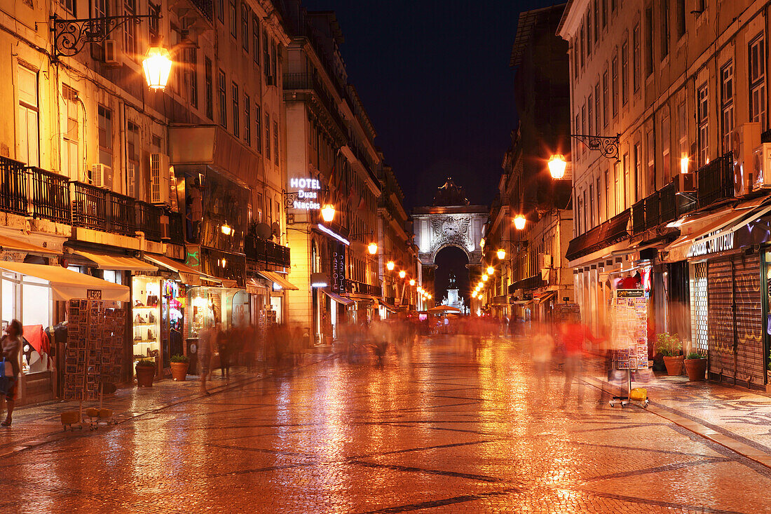 Warm summer's night on the cobbled Rua Augusta, leading to Arch of Rua Augusta, in the Baixa district of Lisbon, Portugal, Europe