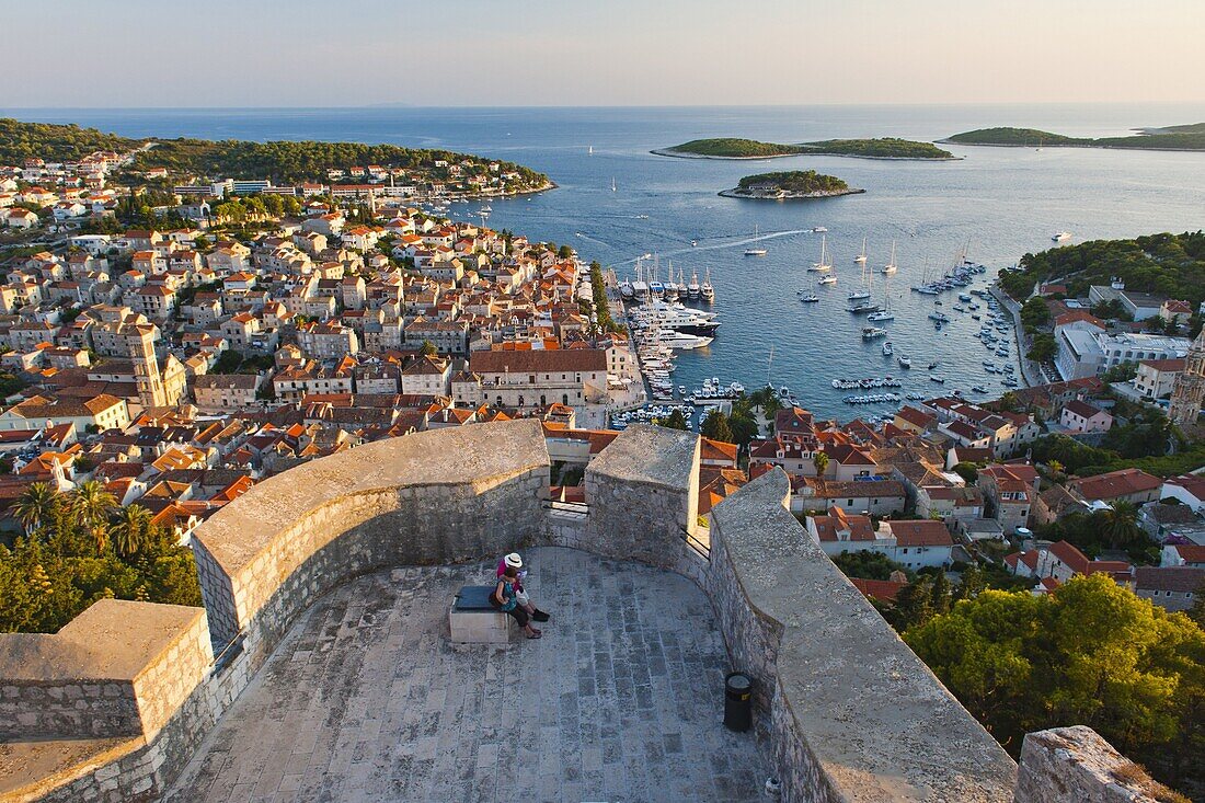 Hvar Town and tourists at Hvar Spanish Fort (Fortica) at sunset, Hvar Island, Dalmatian Coast, Adriatic, Croatia, Europe