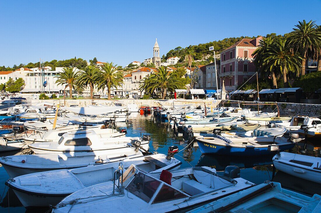 Hvar town centre, boats in Hvar harbour and church bell tower, Hvar Island, Dalmatian Coast, Adriatic, Croatia, Europe