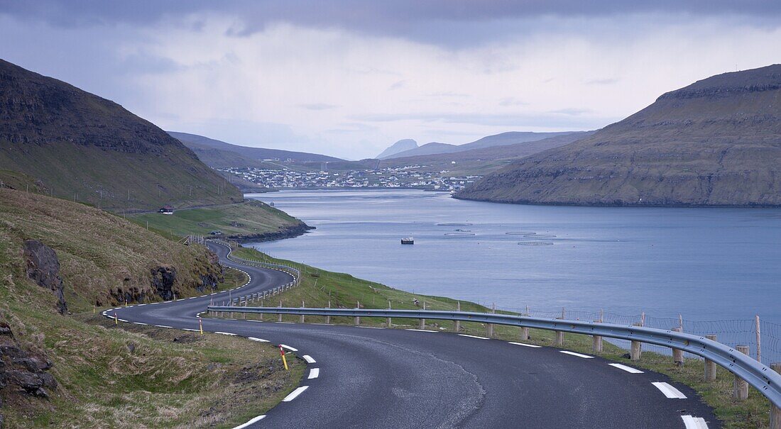 Winding coastal road leading to Sorvagur on the island of Vagar, Faroe Islands, Denmark, Europe
