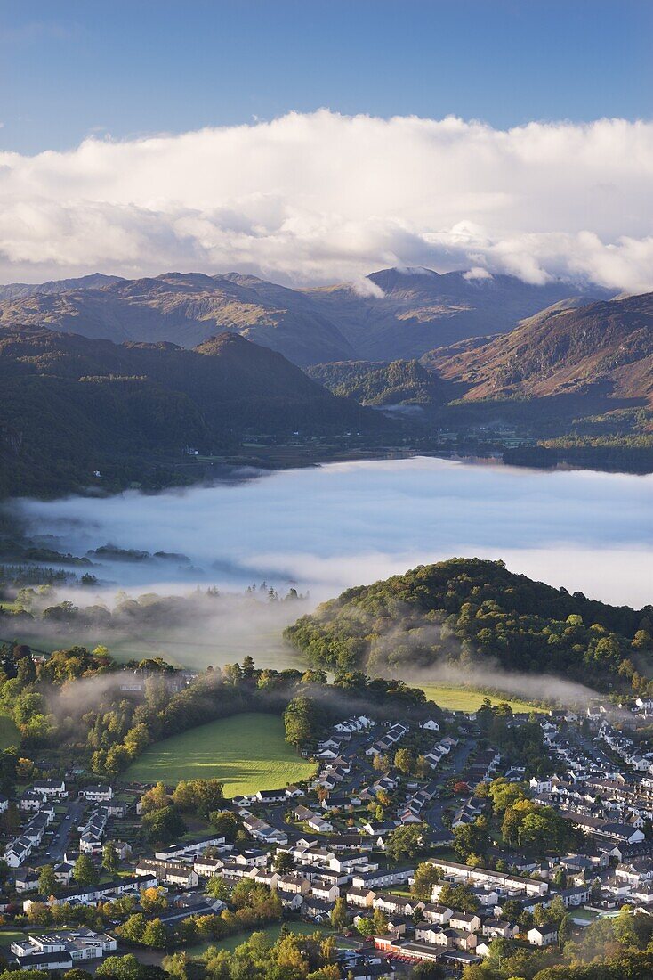 Aerial view over Keswick to a mist covered Derwent Water, Lake District National Park, Cumbria, England, United Kingdom, Europe
