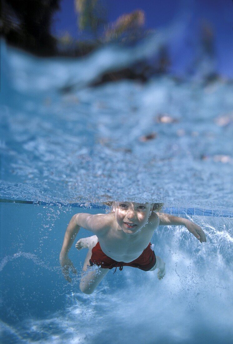Little boy swimming underwater