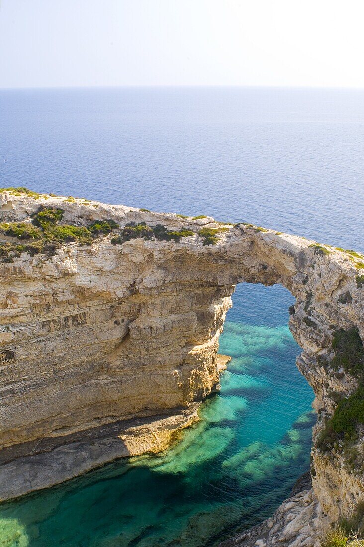 A view of the Trypitos Arch on the south coast of Paxos, Ionian Islands, Greek Islands, Greece, Europe