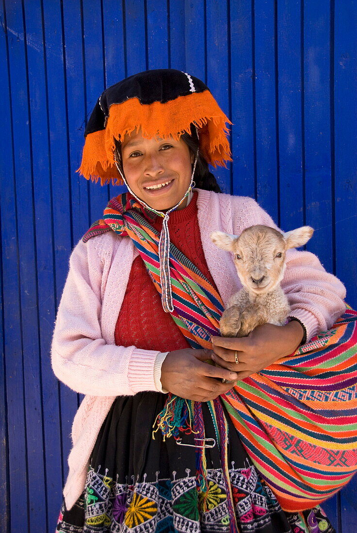 Inca woman in traditional dress with small lamb, Pisac, Sacred Valley, Peru, South America