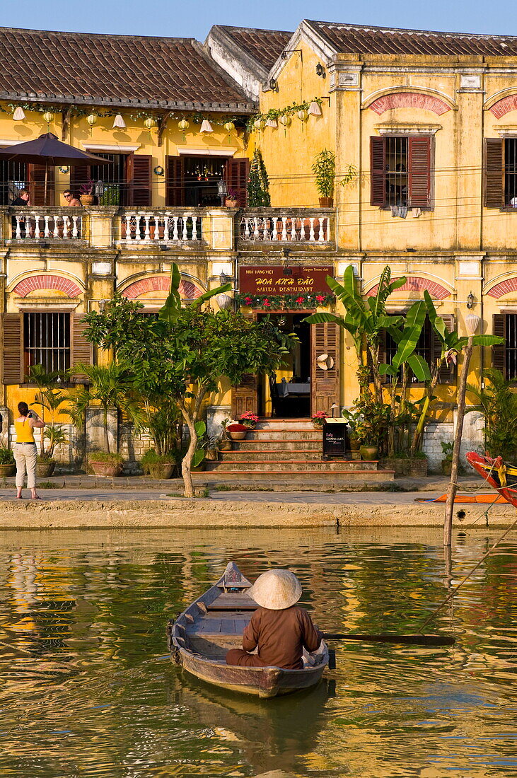 Traditionally dressed old man sitting in his little fishing boat, Hoi An, Vietnam, Indochina, Southeast Asia, Asia