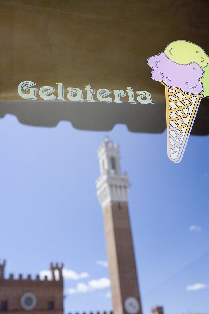 The tower of Palazzo Pubblico reflected in Gelateria window, Piazza del Campo, Siena, Tuscany, Italy, Europe