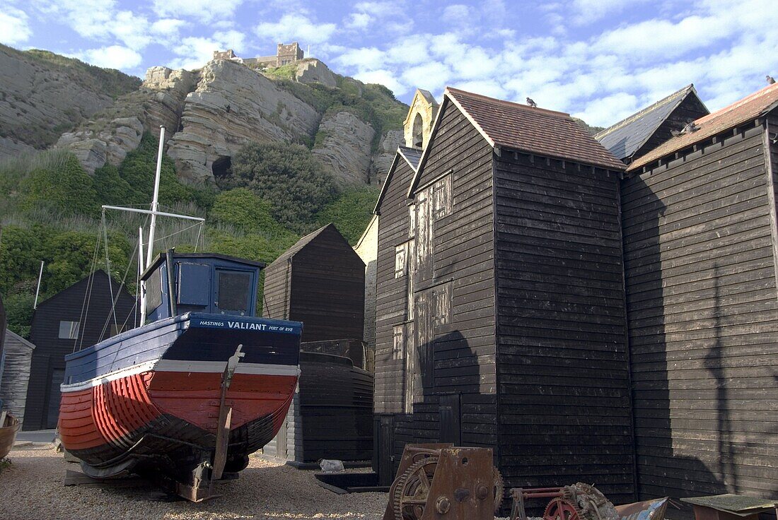 Fishing boat and historic buildings with Hastings Castle in the background, Hastings, Hastings, Sussex, England, United Kingdom, Europe