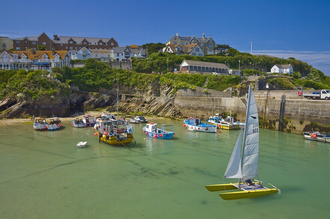 Small fishing boats and a catamaran at low tide, Newquay harbour, Newquay, Cornwall, England, United Kingdom, Europe