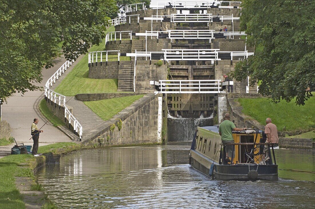 Narrow boat entering the bottom lock of the five lock ladder on the Liverpool Leeds canal, at Bingley, Yorkshire, England, United Kingdom, Europe