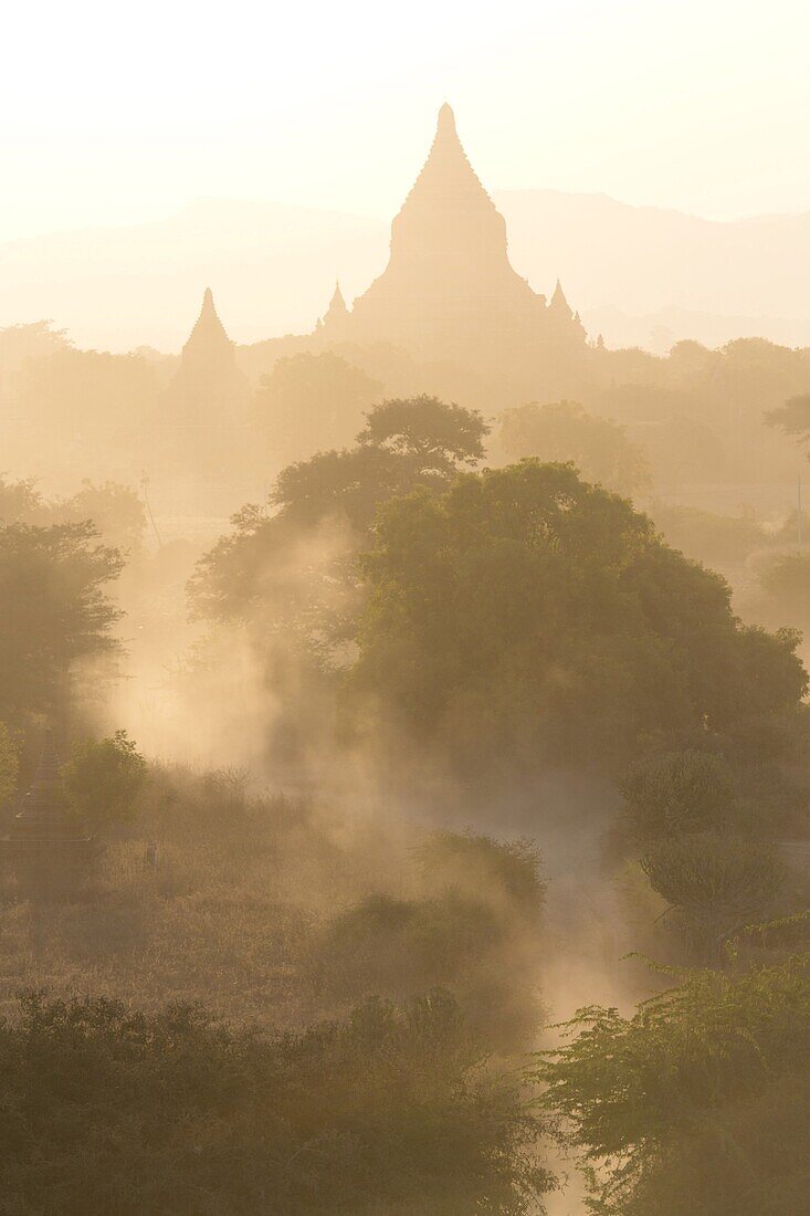 View over the temples of Bagan swathed in dust and evening sunlight, from Shwesandaw Paya, Bagan, Myanmar (Burma), Southeast Asia