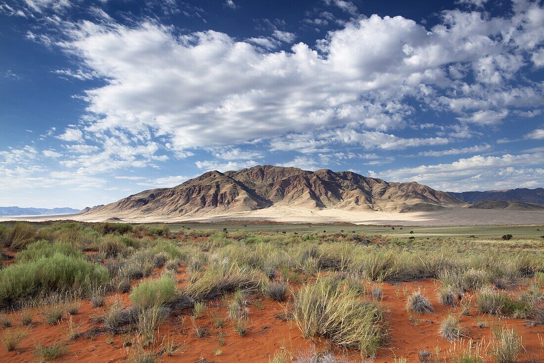 View across magnificent landscape of orange sand dunes and sandstones mountains at Wolwedans, part of the Namib Rand game reserve, Namib Naukluft Park, Namibia, Africa