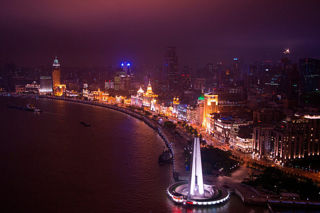 Overhead of the Bund along Huangpu River with with People's Heroes Memorial at night, Shanghai, Shanghai, Asia