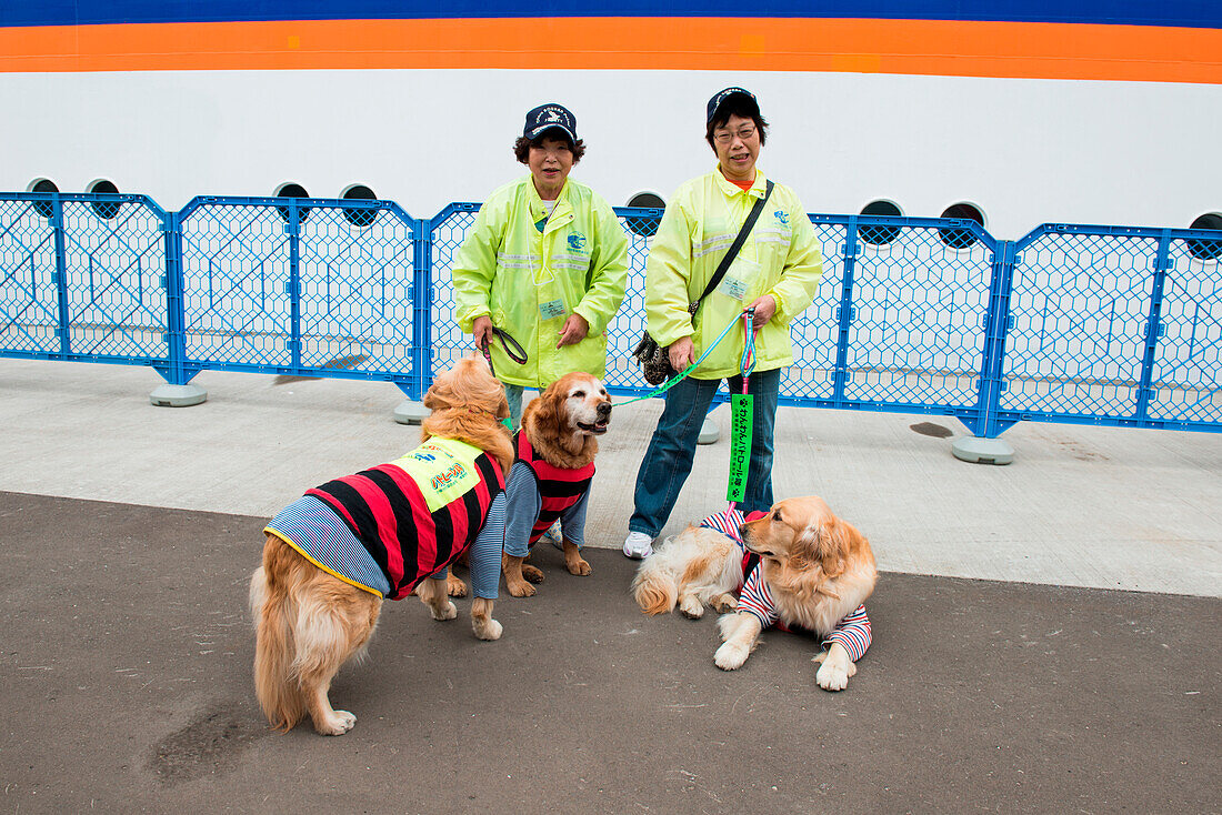 Two women and three dogs at pier, Otaru, Hokkaido, Japan, Asia