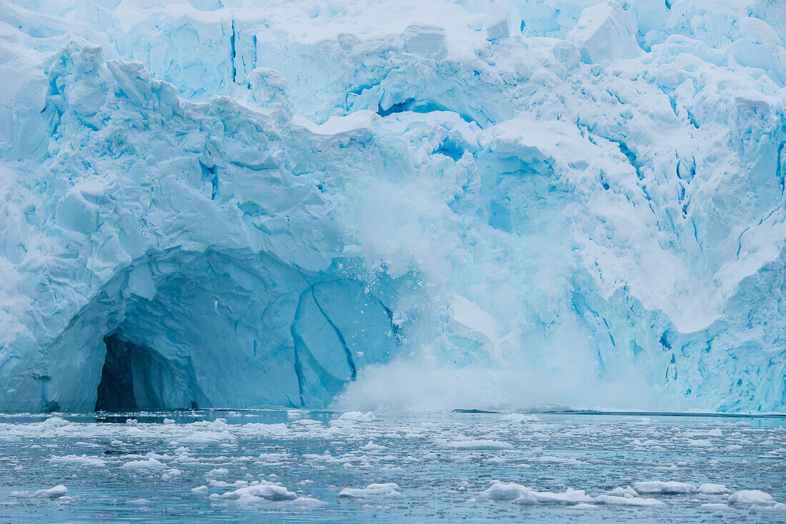 Blocks of glacial ice crash into sea, Paradise Bay (Paradise Harbor), Danco Coast, Graham Land, Antarctica