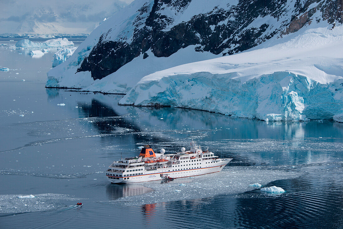 Overhead of expedition cruise ship MS Hanseatic (Hapag-Lloyd Cruises) at anchor with icy landscape, Neko Harbour, Graham Land, Antarctica