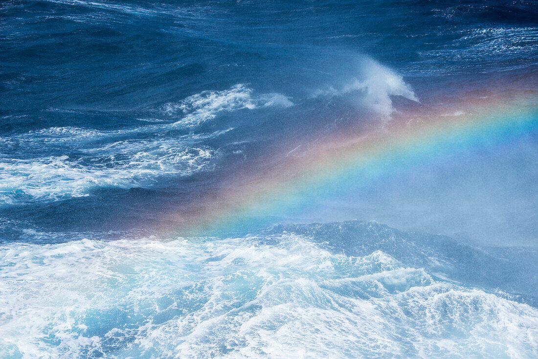 Rainbow in sea spray during rough seas, between South Georgia Island and Elephant Island, South Shetland Islands, Antarctica