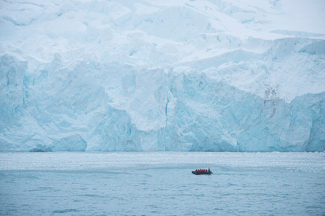 Zodiac dinghy excursion from expedition cruise ship MS Hanseatic (Hapag-Lloyd Cruises) in front of giant ice shelf, Elephant Island, South Orkney Islands, Antarctica