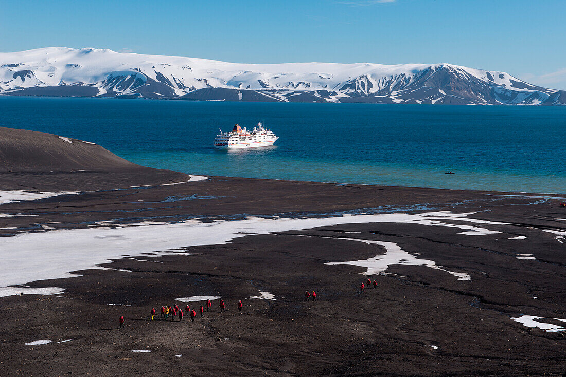 Overhead of passengers from expedition cruise ship MS Hanseatic (Hapag-Lloyd Cruises) on trek to crater, Telephone Bay, Deception Island, South Shetland Islands, Antarctica