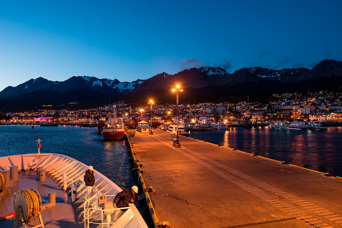 Expedition cruise ship MS Hanseatic (Hapag-Lloyd Cruises) departs pier at dusk, Ushuaia, Tierra del Fuego, Patagonia, Argentina