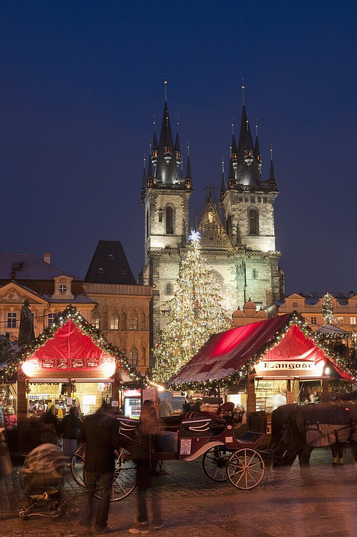 Horse drawn carriage at Christmas Market and Gothic Tyn Church at twilight, Old Town Square, Stare Mesto, Prague, Czech Republic, Europe