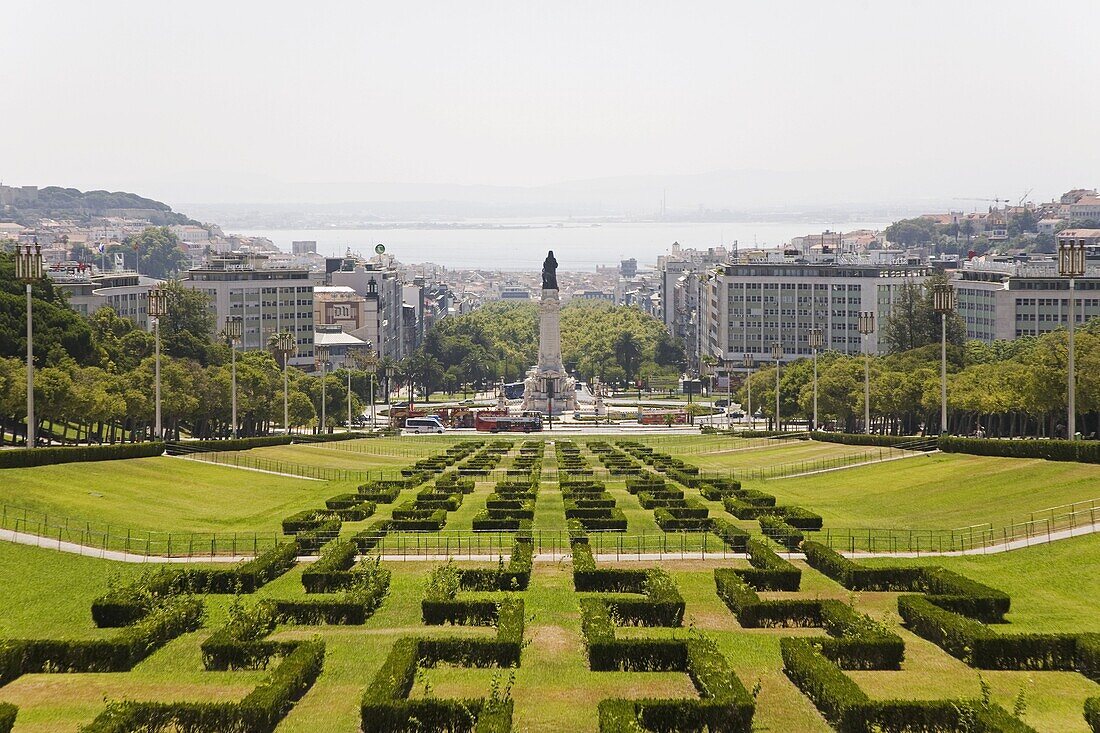 The greenery of the Parque Eduard VII runs towards the Marques de Pombal memorial in central Lisbon, Portugal, Europe