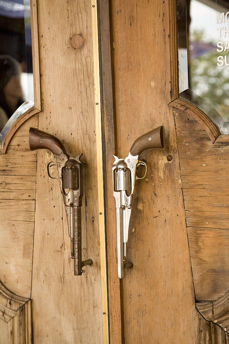 A pair of guns on doorway to restaurant in Houston, Texas, United States of America, North America