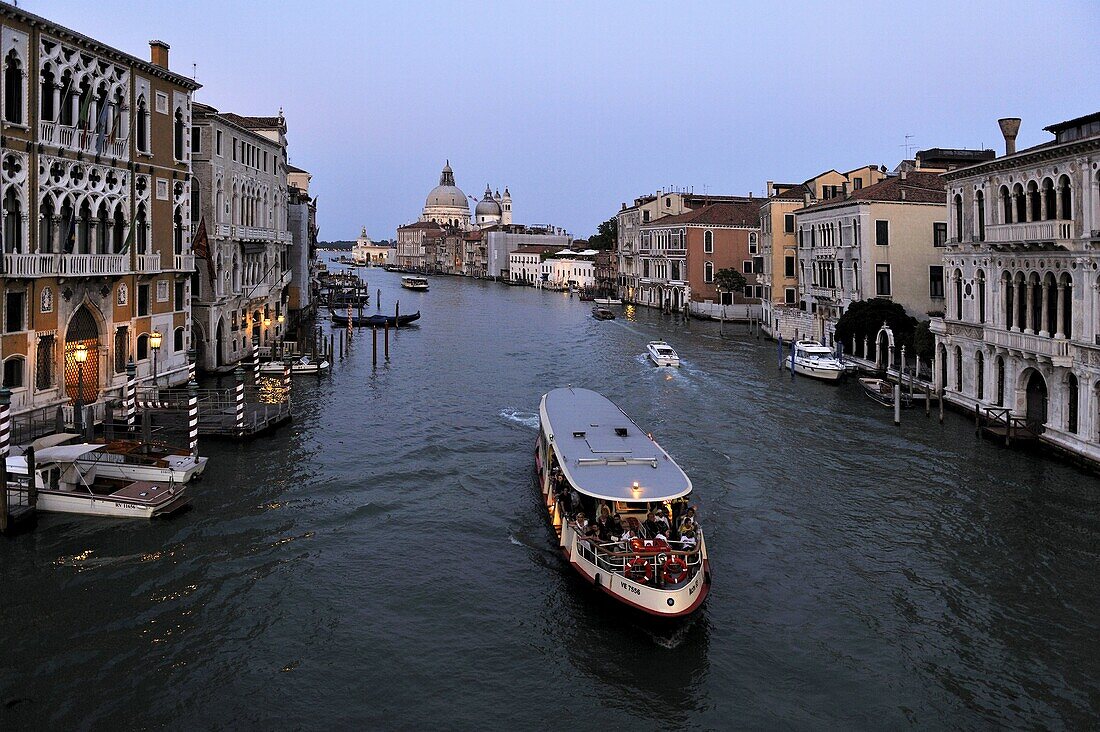Evening view of a vaporetto (water bus) on the Grand Canal, Venice, UNESCO World Heritage Site, Veneto, Italy, Europe