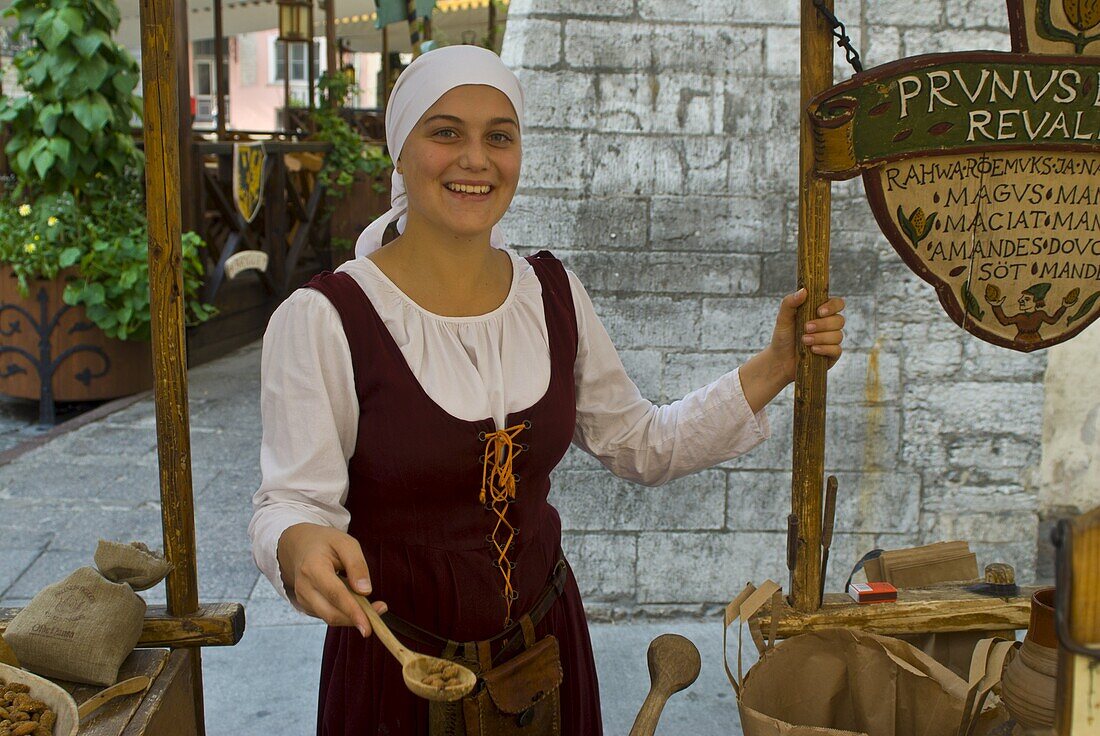 Traditionally dressed girl selling stuff from the Middle Ages, Tallinn, Estonia, Baltic States, Europe