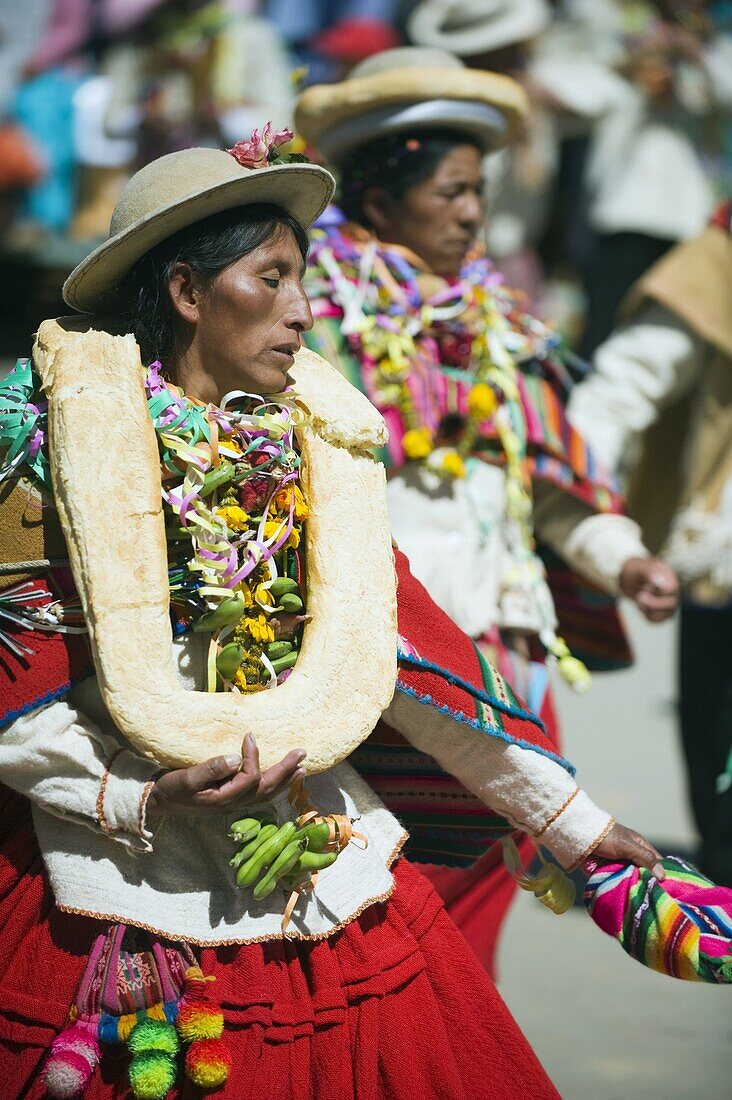 Women wearing bread decoration, Anata Andina harvest festival, Carnival, Oruro, Bolivia, South America