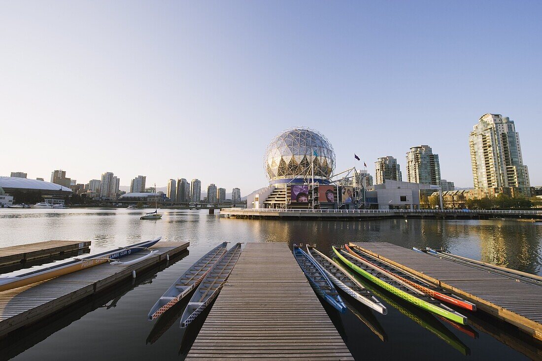 Colourful rowing boats in front of Telus Science World, on False Creek, Vancouver, British Columbia, Canada, North America