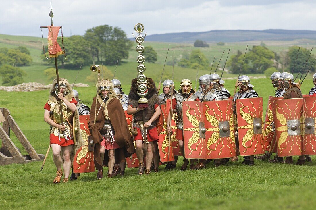 Roman soldiers of the Ermine Street Guard, marching in column led by Standard Bearers and Trumpeter, Birdoswald Roman Fort, Hadrians Wall, Northumbria, England, United Kingdom, Euruope