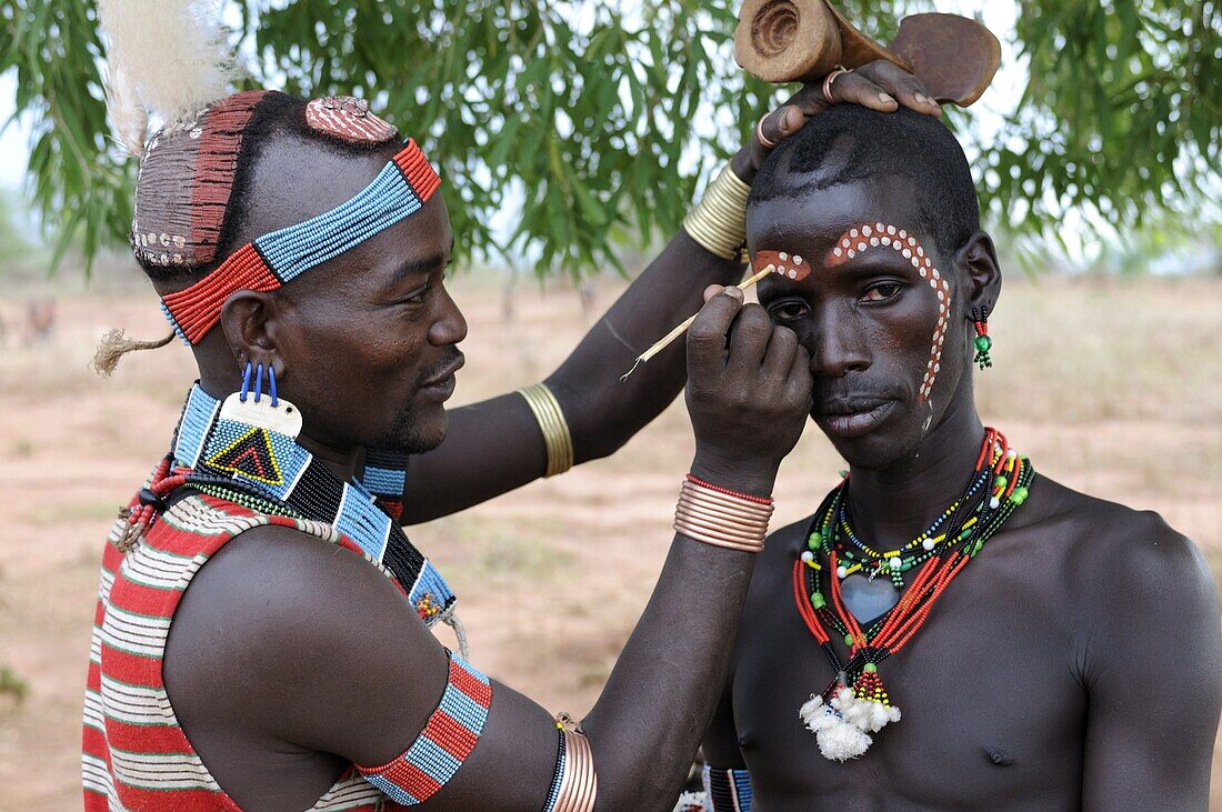 Two men from the Hamer tribe preparing for the Jumping of the Bull ceremony, Omo Valley, Southern Ethiopia, Ethiopia, Africa