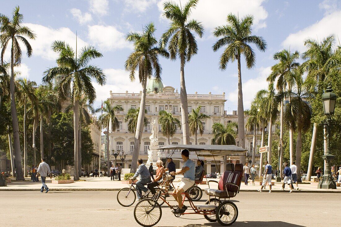 Cyclo-taxis passing the Parque Central, Central Havana, Cuba, West Indies, Central America