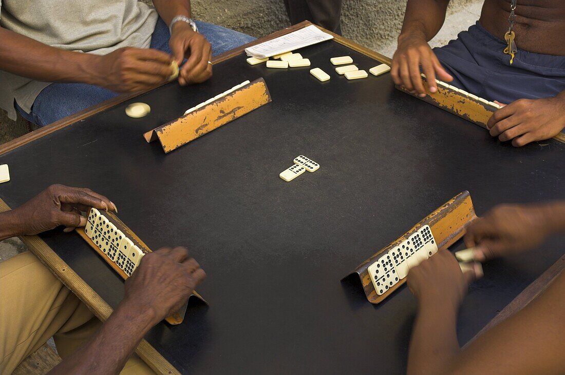 Close-up of the hands of a group of four people playing dominos in the street Centro Habana, Havana, Cuba, West Indies, Central America
