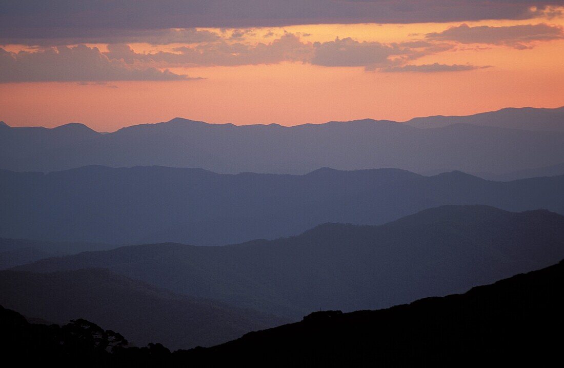 Landscape view, twilight glow and mountain ridges of High Country from Mount Feathertop, Alpine National Park, High Country, Victoria, Australia, Pacific