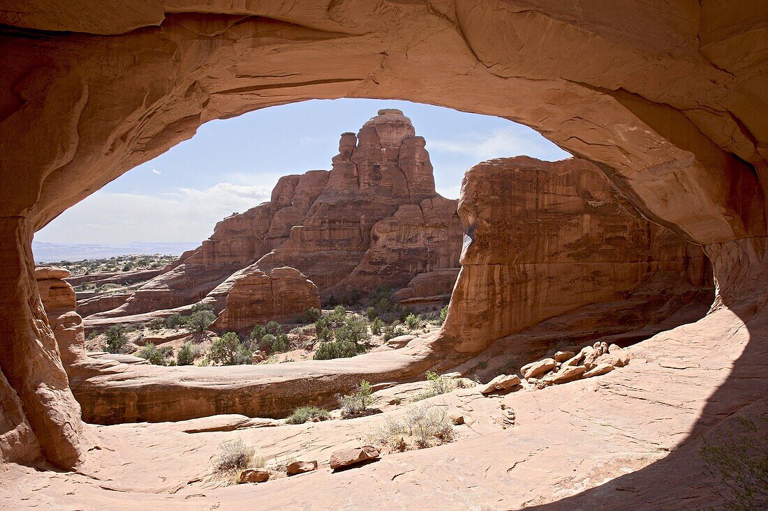 Looking out through Tower Arch, Arches National Park, Utah, United States of America, North America