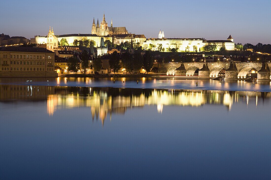 Evening reflection in River Vltava of St. Vitus's Cathedral, Royal Palace, Castle, and Charles Bridge, Prague, Czech Republic, Europe