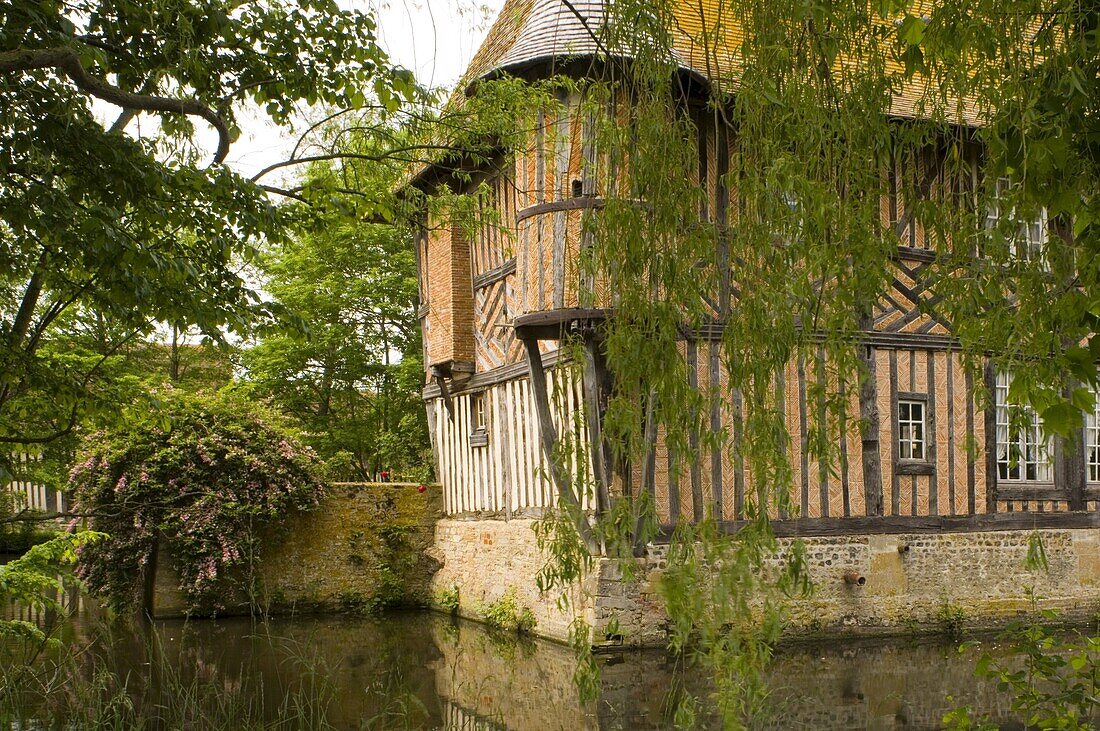 The half timbered manoire (manor house) and surrounding moat in Coupesarte, Normandy, France, Europe