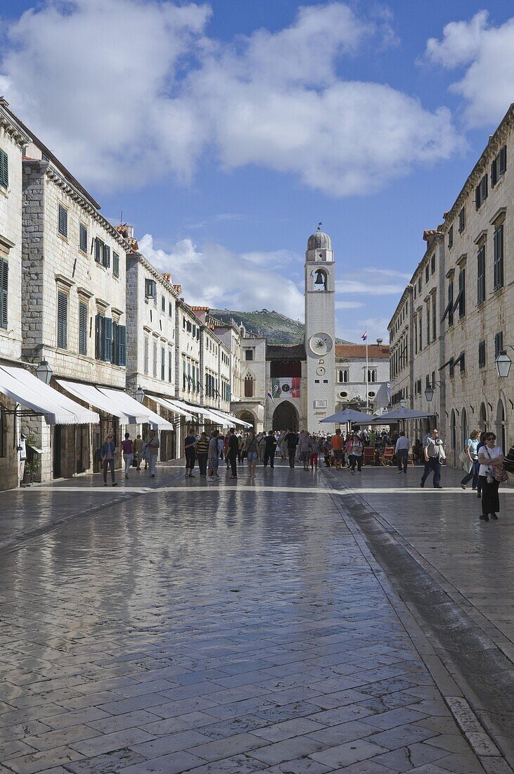 Foot worn glossy roadway in the main street dominated by the clock tower. medieval city of Dubrovnik, UNESCO World Heritage Site, Croatia, Europe
