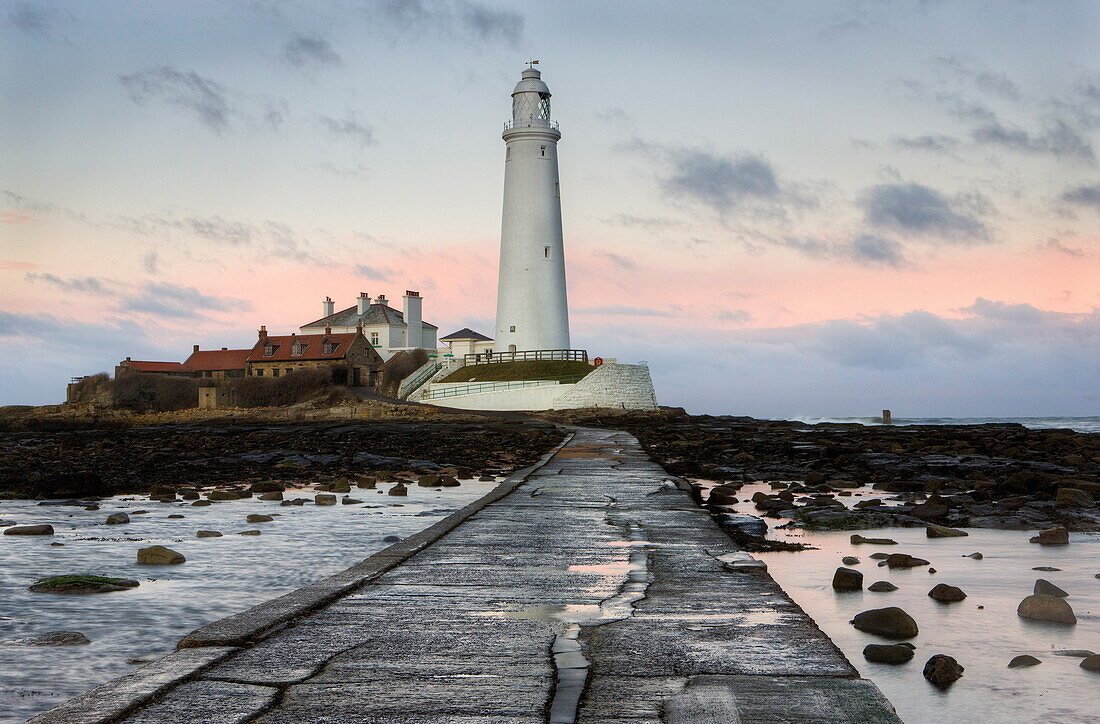 View along the tidal causeway to St. Mary's Island and St. Mary's Lighthouse at dusk, near Whitley Bay, Tyne and Wear, England, United Kingdom, Europe