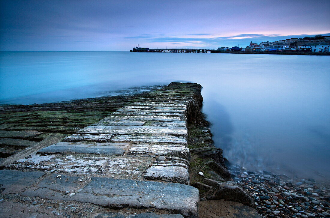 Stone jetty and new pier at dawn, Swanage, Dorset, England, United Kingdom, Europe