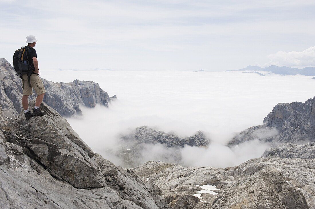 Hiker on Tesorero Peak, Picos de Europa National Park, shared by the provinces of Asturias, Cantabria and Leon, Spain, Europe