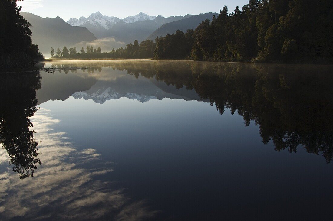 Lake Matheson in the evening reflecting a near perfect image of Mount Tasman and Aoraki (Mount Cook), 3754m, Australasia's highest mountain, South Island, New Zealand, Pacific