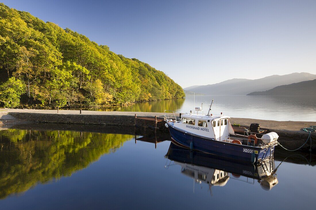 Boat moored in the small Inversnaid Hotel harbour on Loch Lomond, Loch Lomond and The Trossachs National Park, Stirling, Scotland, United Kingdom, Europe
