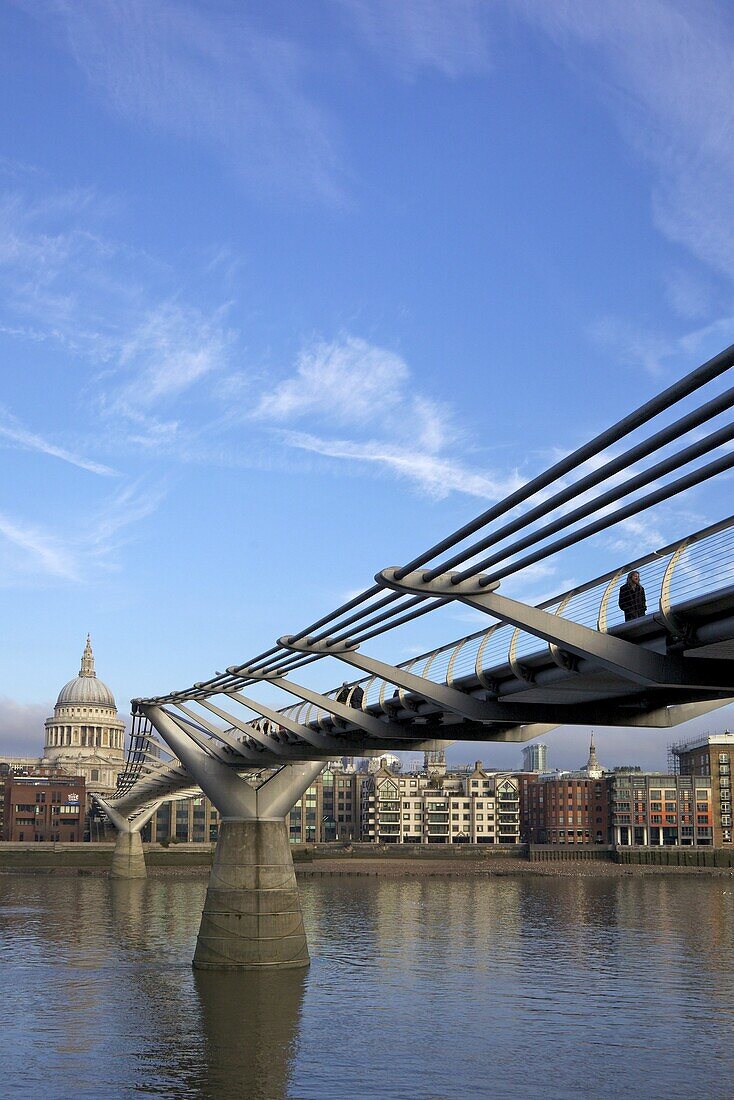 Pedestrians on Millennium Bridge, crossing the River Thames, taken from Bankside looking to St. Pauls Cathedral, London, England, United Kingdom, Europe