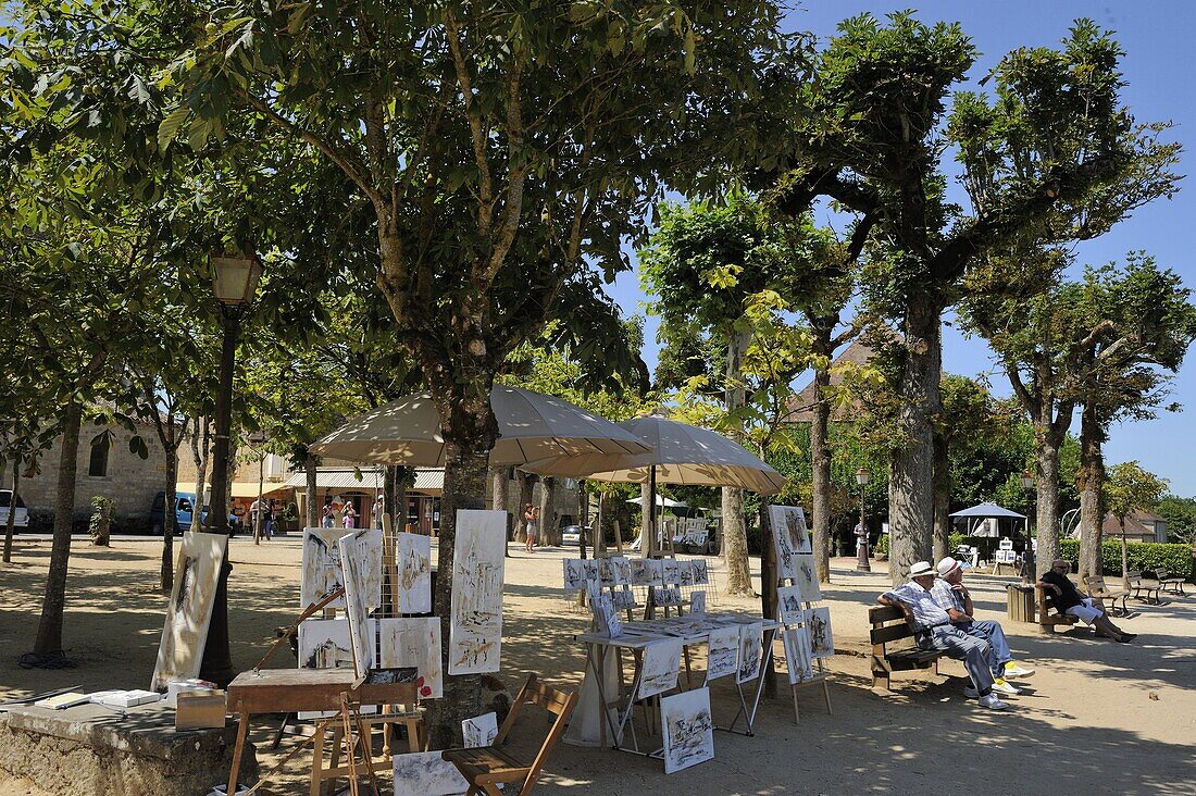 Artist's stall in a tree lined promenade, Bastide town, Domme, Les Plus Beaux Villages de France, Dordogne, France, Europe