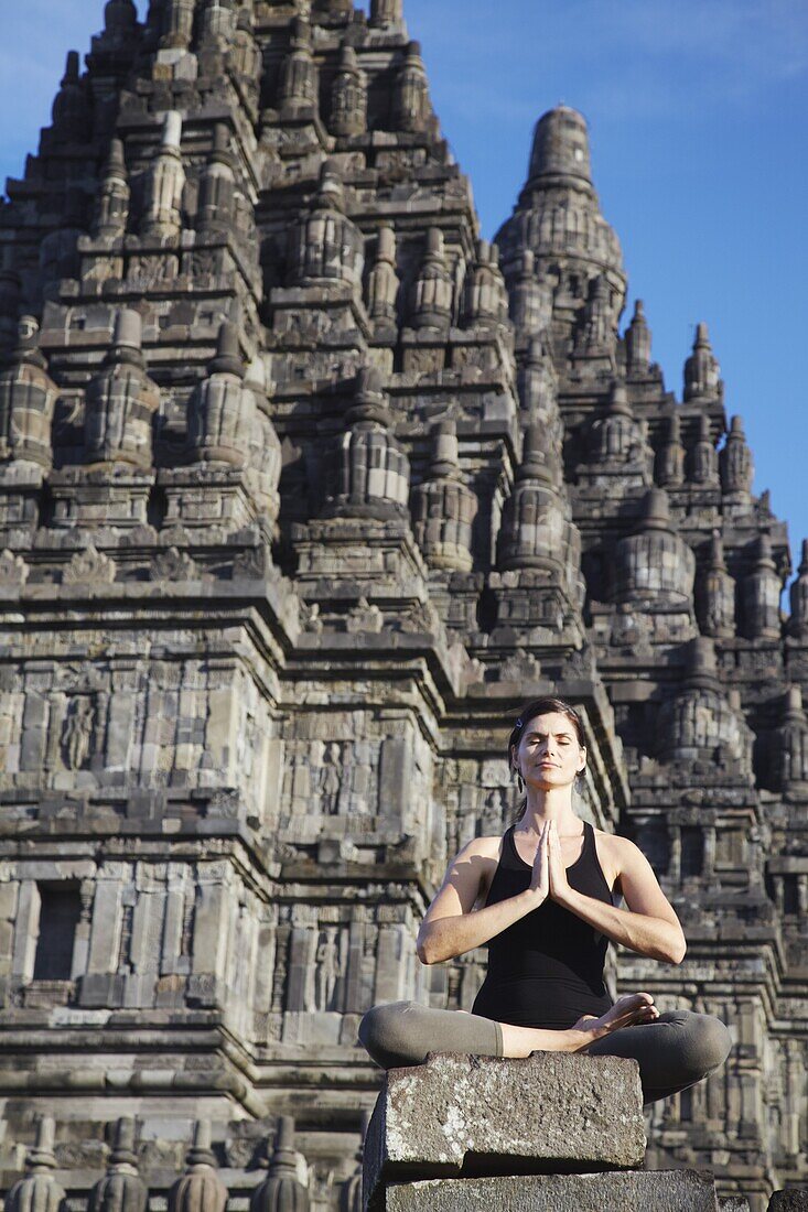 Woman performing yoga, Prambanan complex, UNESCO World Heritage Site, Java, Indonesia, Southeast Asia, Asia