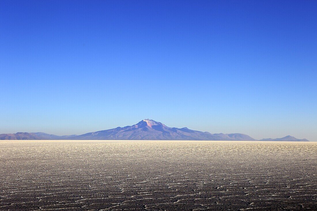 Salar de Uyuni salt flat and Mount Tunupa, Andes mountains in the distance in south-western Bolivia, South America