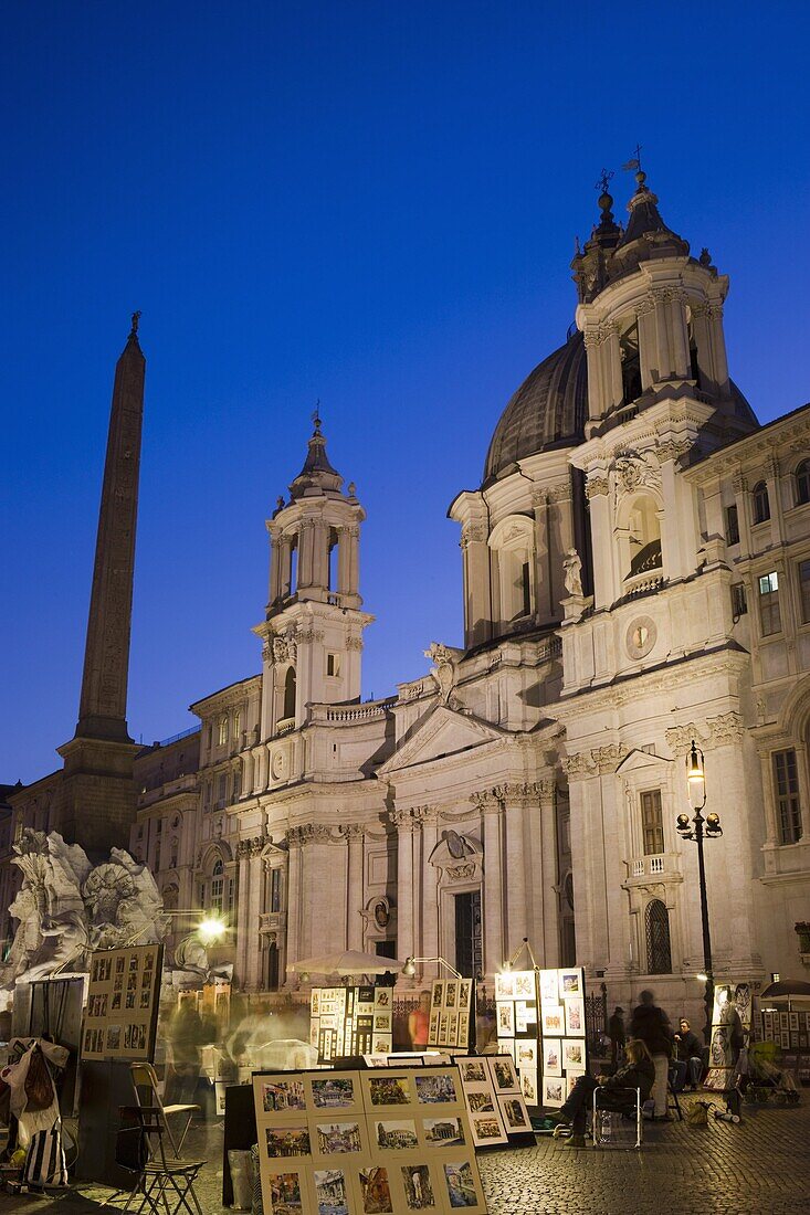 Artist stalls, Fontana dei Fiumi and San' Agnese in Agone, evening, Piazza Navona, Rome, Lazio, Italy, Europe